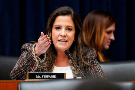 Woman gestures as she speaks into mic